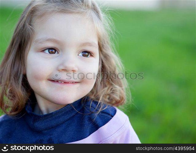 Cute little girl with a beautiful smil in the park