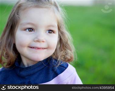 Cute little girl with a beautiful smil in the park