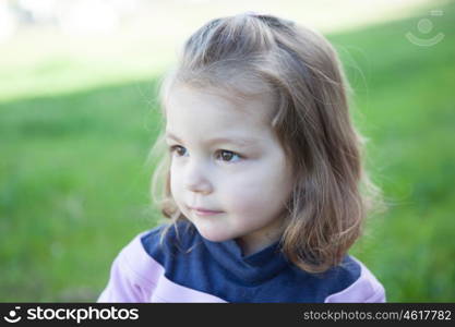 Cute little girl with a beautiful smile in the park