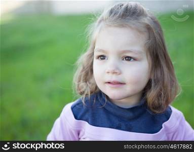 Cute little girl with a beautiful smile in the park
