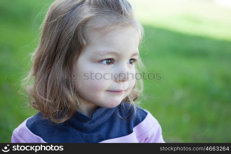 Cute little girl with a beautiful smile in the park