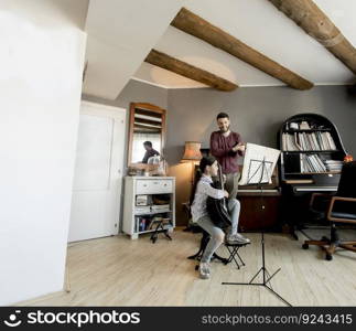 Cute little girl with guitar teacher in the room at home