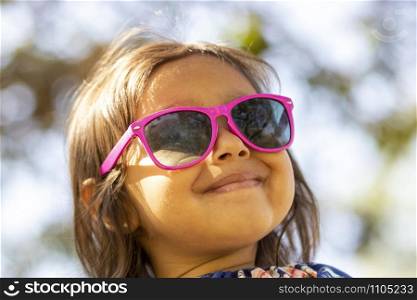 Cute little girl with pink sunglasses