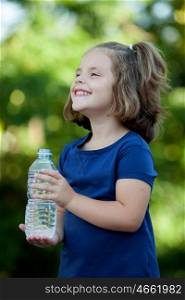 Cute little girl with water bottle in the park
