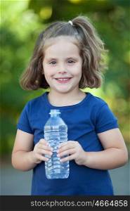 Cute little girl with water bottle in the park
