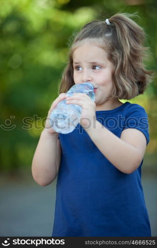 Cute little girl with water bottle in the park