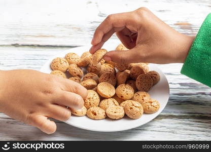 Cute little girls is playing with Santa's cookies and milk at Christmas