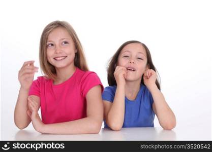 Cute little girls laughing on white background