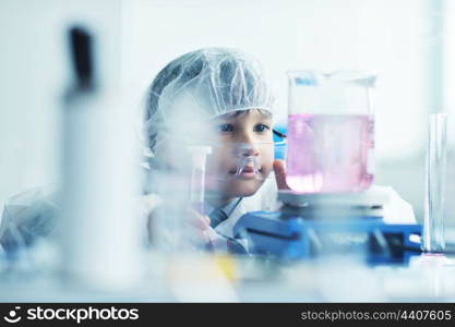 cute little male child have experiment with test tubes in bright modern lab