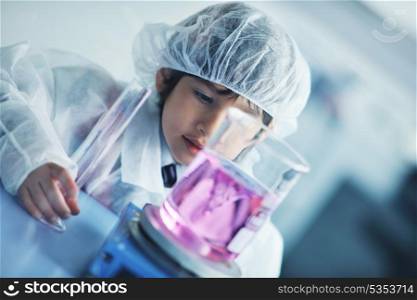 cute little male child have experiment with test tubes in bright modern lab