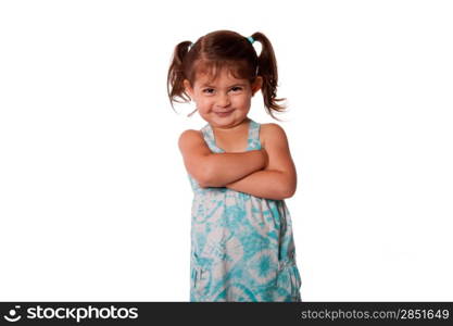 Cute little young toddler girl with attitude smirk, arms crossed and pigtails in hair, naughty rascal expression, isolated.