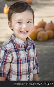 Cute Mixed Race Young Boy Having Fun at the Pumpkin Patch.