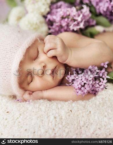 Cute newborn child sleeping on the soft carpet