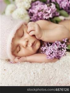 Cute newborn child sleeping on the soft carpet