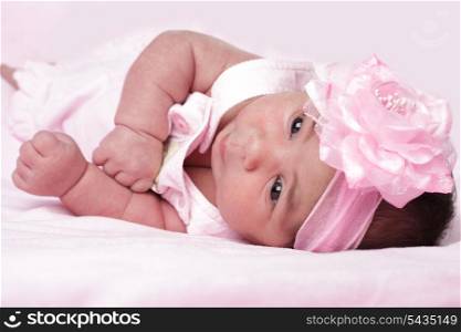 Cute newborn girl in pink dress