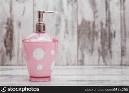 Cute pink bathroom accessories on white wooden background