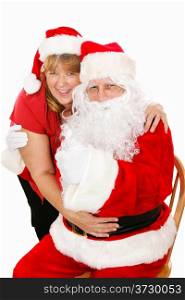 Cute portrait of Santa Clause getting a hug from his wife. Isolated on white.