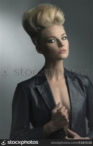 cute portrait of very fashion beautiful girl posing with blonde creative hair-style and leather jacket