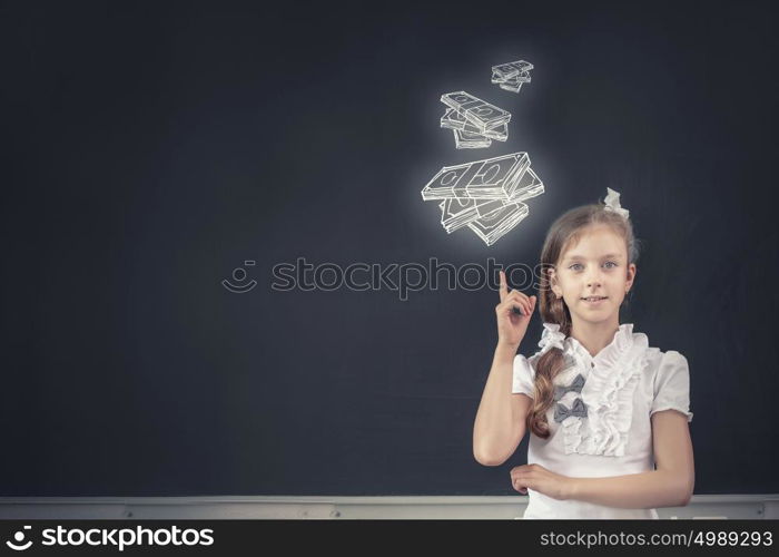 Cute school girl and drawn money banknotes on blackboard. Money science