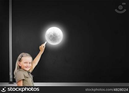 Cute school girl drawing moon on blackboard . What do we know about moon