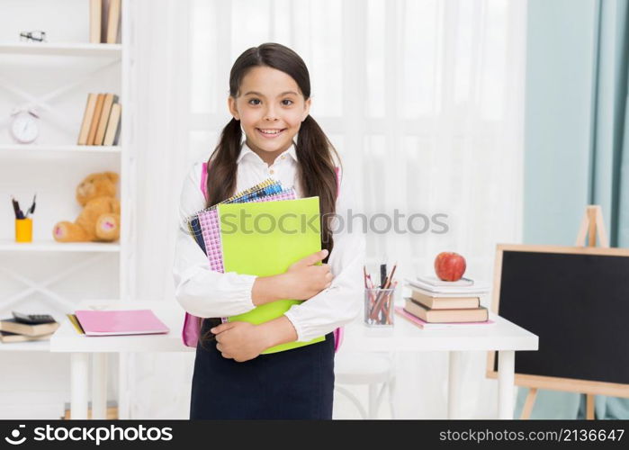 cute schoolgirl uniform holding notepads classroom