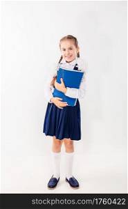 Cute schoolgirl with notebooks and books on a white background. Satisfied students.. Cute schoolgirl with notebooks and books on a white background.