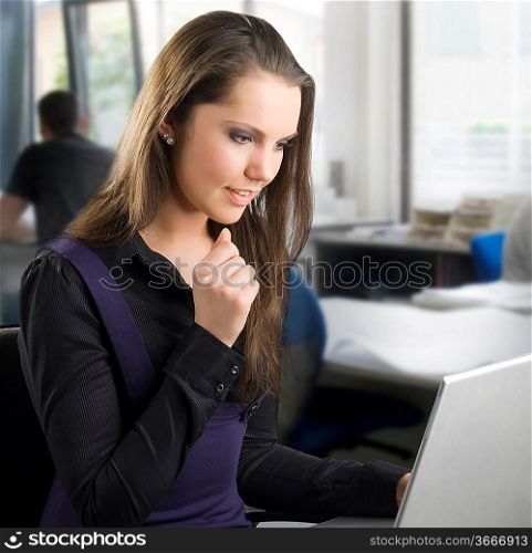 cute secretary working in front of the computer looking happy