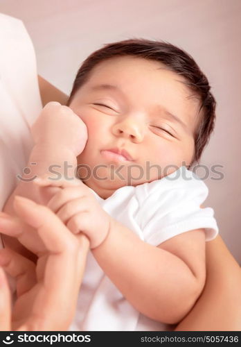 Cute sleeping baby portrait, mother holding on hands sweet newborn toddler, happy childhood, new life concept