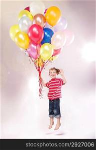 Cute small child hovering by the ballons