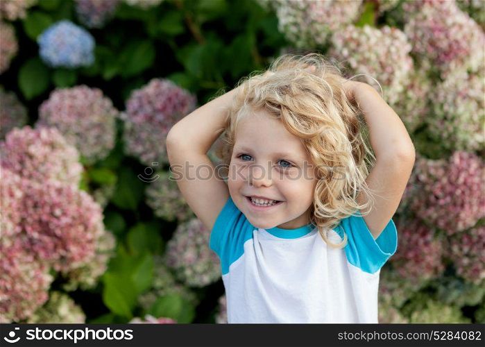 Cute small child with long hair in the garden