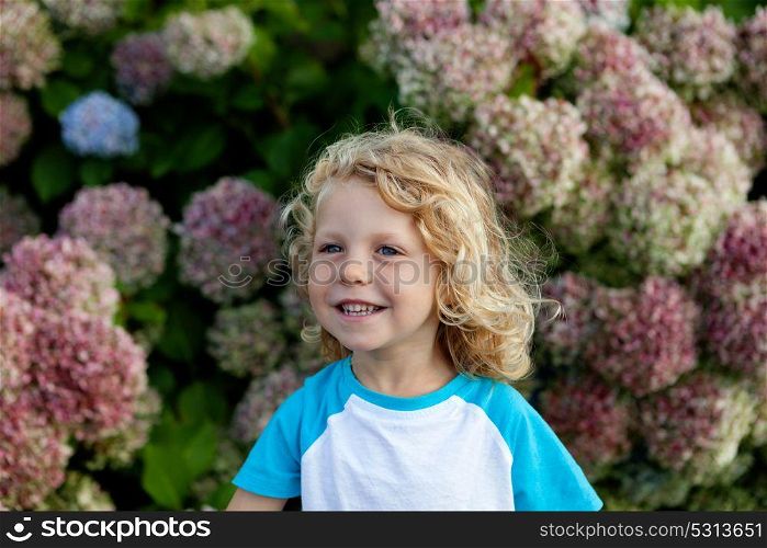 Cute small child with long hair in the garden
