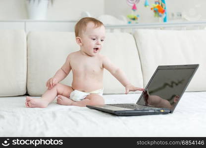 Cute smiling baby boy looking with interest