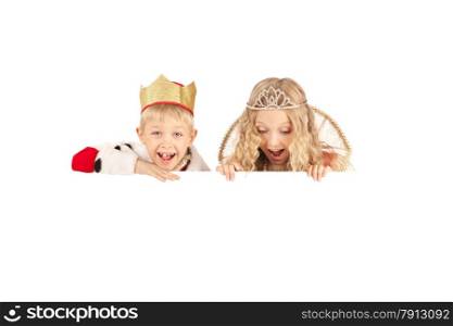 Cute smiling boy and girl in the king and queen costumes holding the sign