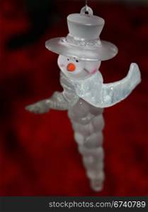 Cute snowman icicle ornament hanging on the Christmas tree