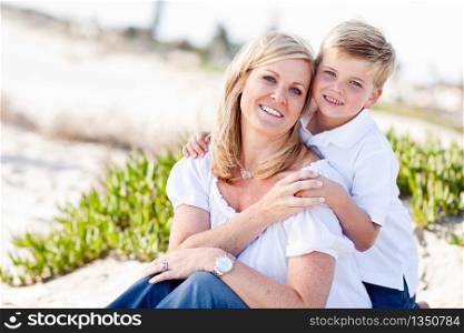 Cute Son Hugs His Attractive Mom Portrait at The Beach.