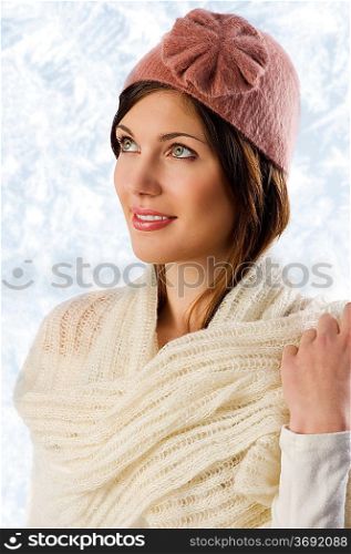 cute sweet girl with white scarf and a pink winter cap looking up and smiling