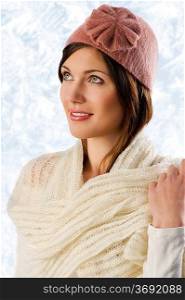 cute sweet girl with white scarf and a pink winter cap looking up and smiling