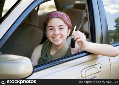 Cute teen girl excited to have the car keys.