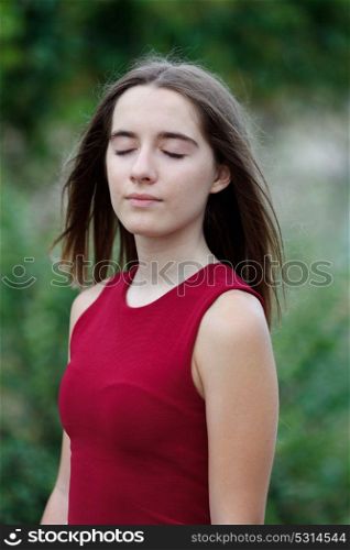 Cute teenager girl in a park surrounded by plants