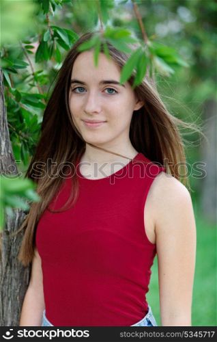 Cute teenager girl in a park surrounded by plants