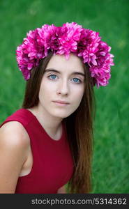 Cute teenager girl in a park with a beautiful wreath on her head