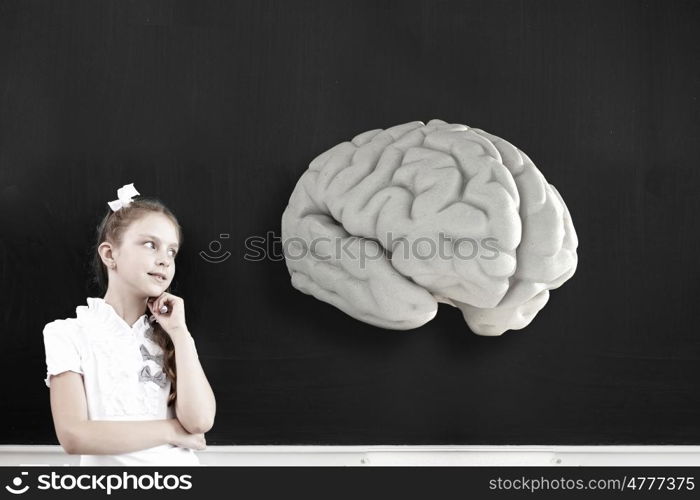 Cute thoughtful school girl and brain above her head. Let me think