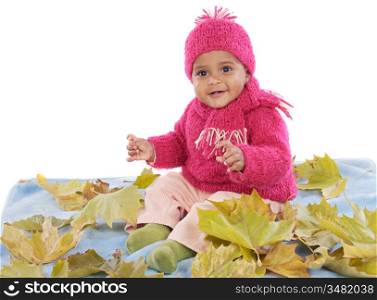 Cute toddler girl playing with fallen leaves