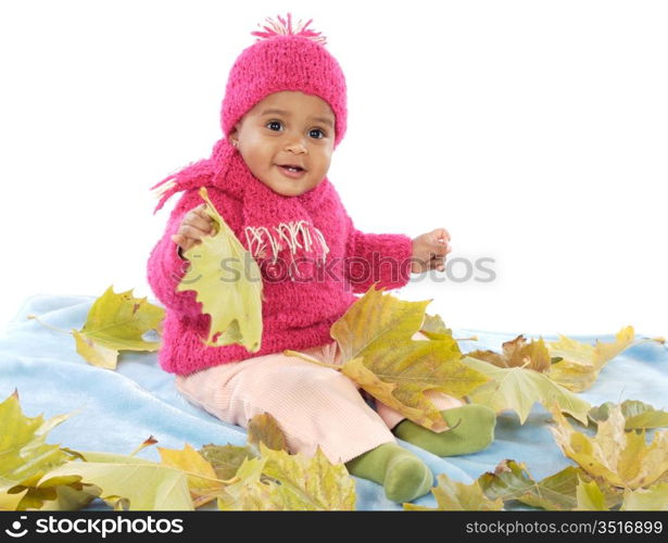 Cute toddler girl playing with fallen leaves