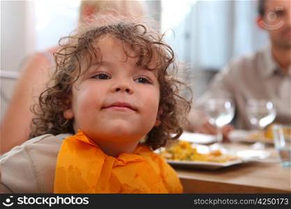 cute toddler having dinner with parents