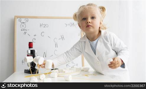 cute toddler learning about science with whiteboard microscope
