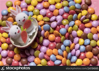 cute two bunnies inside broken easter egg colorful gem candies