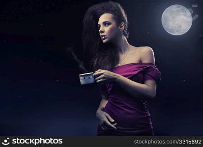 Cute woman drinking coffee on the midnight