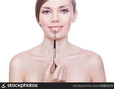cute woman with brush on lips on white background