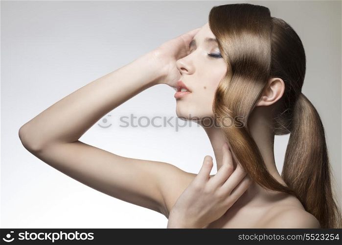 cute woman with creative shiny smooth hair style and wavy tuft near the face, perfect skin, pretty make-up, sensual pose